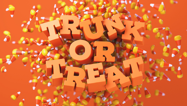 Bold 3D orange text reading "TRUNK OR TREAT" with candy corn pieces scattered on an orange background.